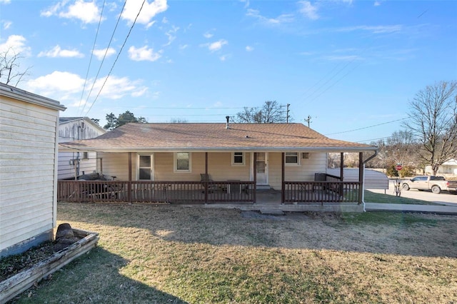 back of property featuring a porch and a lawn