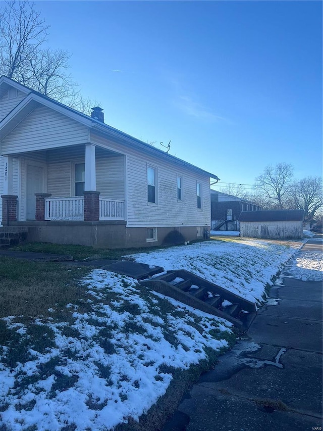 view of snowy exterior with a porch