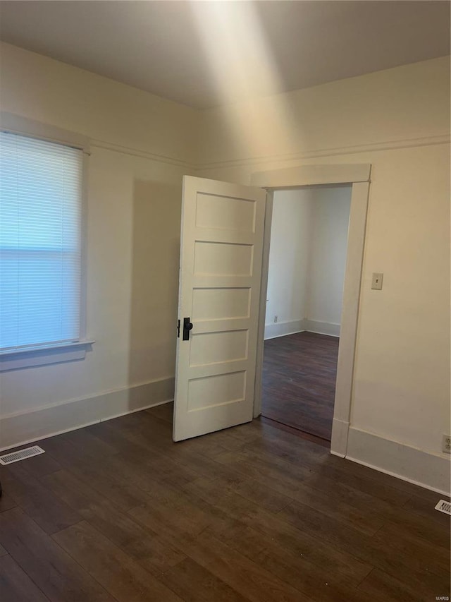 spare room featuring dark hardwood / wood-style flooring