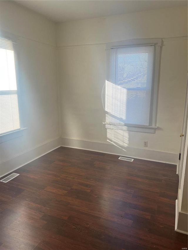 spare room featuring dark hardwood / wood-style flooring