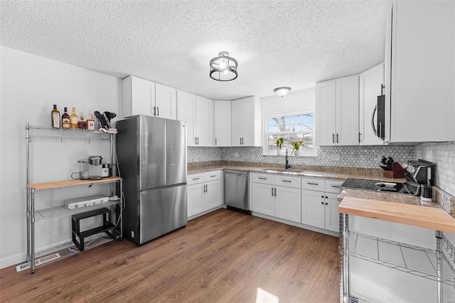 kitchen featuring white cabinetry, appliances with stainless steel finishes, sink, and dark wood-type flooring