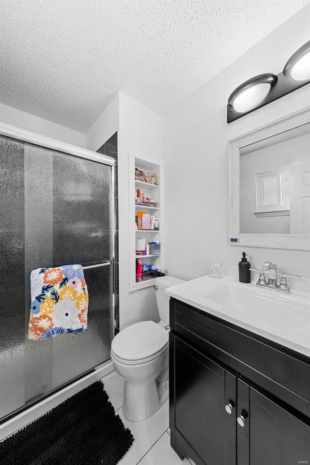 bathroom with tile patterned floors, toilet, an enclosed shower, a textured ceiling, and vanity