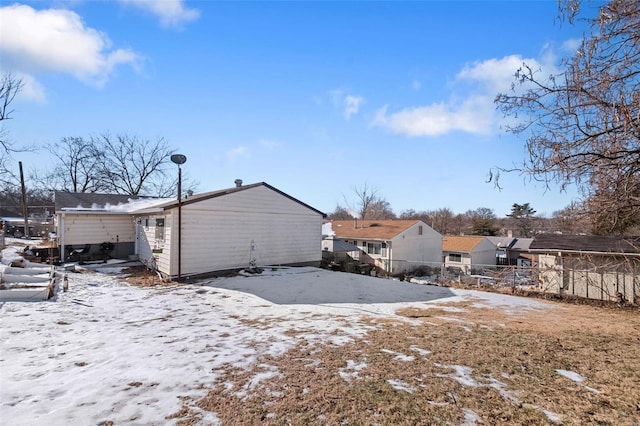 view of snow covered back of property