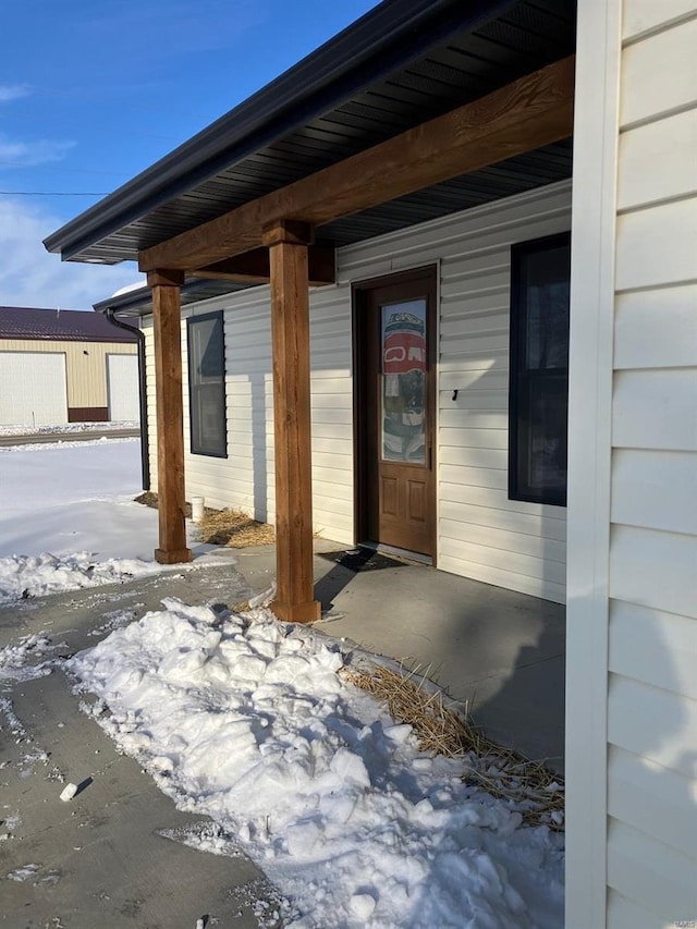 view of snow covered property entrance