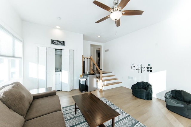 living room featuring recessed lighting, a ceiling fan, stairs, light wood-type flooring, and independent washer and dryer