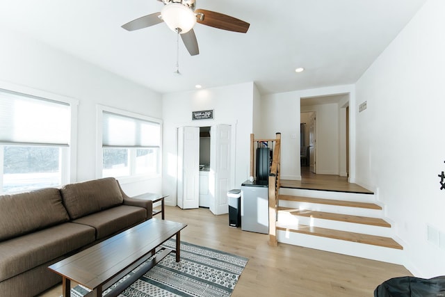 living area with light wood finished floors, ceiling fan, stairway, washer / clothes dryer, and recessed lighting