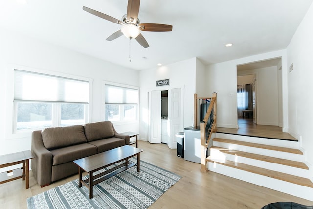 living room featuring light wood-style floors, stairs, a ceiling fan, and recessed lighting