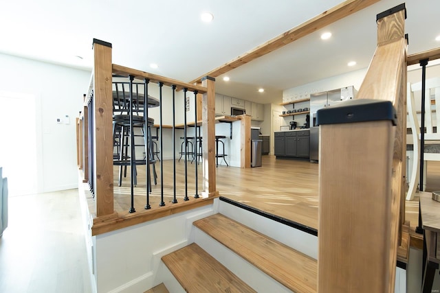 stairway featuring recessed lighting and wood finished floors