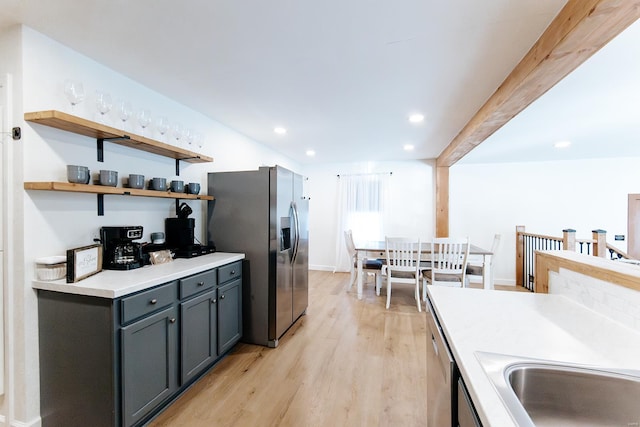 kitchen with light wood-style flooring, recessed lighting, stainless steel appliances, light countertops, and gray cabinets