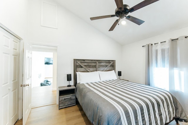 bedroom featuring light wood-style floors, ceiling fan, and vaulted ceiling