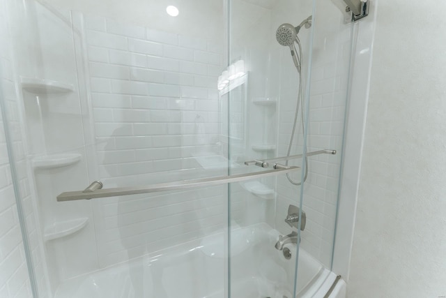 bathroom featuring shower / bath combination with glass door