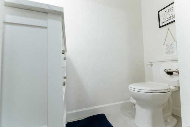 bathroom featuring toilet and baseboards