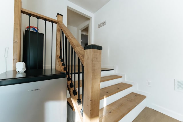 stairs featuring visible vents and baseboards