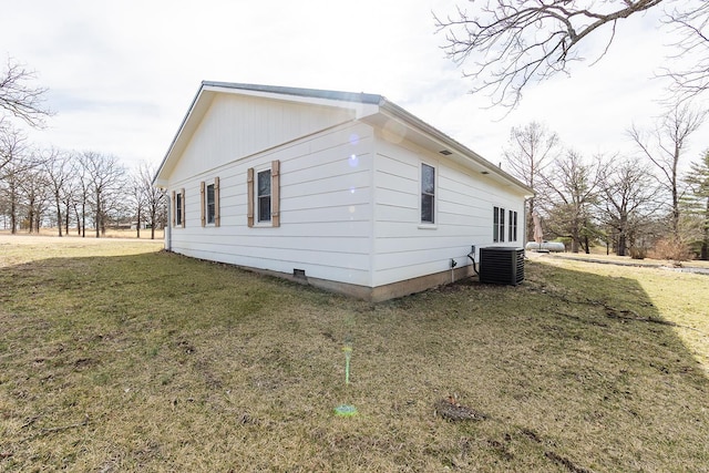 view of side of property with cooling unit and a yard