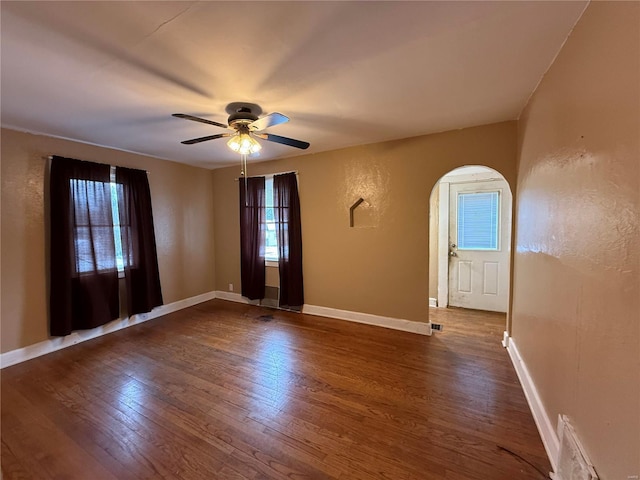 unfurnished room with ceiling fan and dark hardwood / wood-style floors