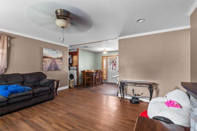 living room with ceiling fan, dark hardwood / wood-style floors, washer / dryer, and ornamental molding