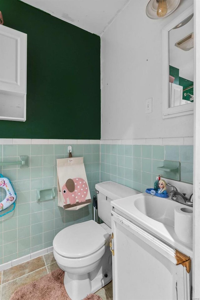 bathroom featuring tile patterned floors, toilet, and vanity