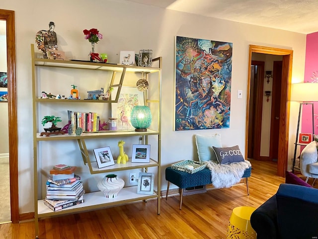 sitting room with hardwood / wood-style flooring