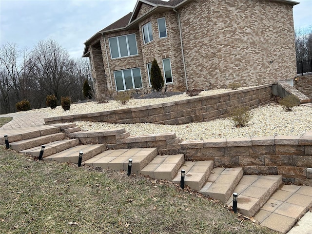 back of property featuring brick siding