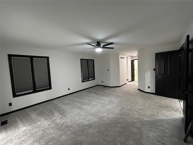 unfurnished bedroom featuring carpet floors, ceiling fan, and baseboards