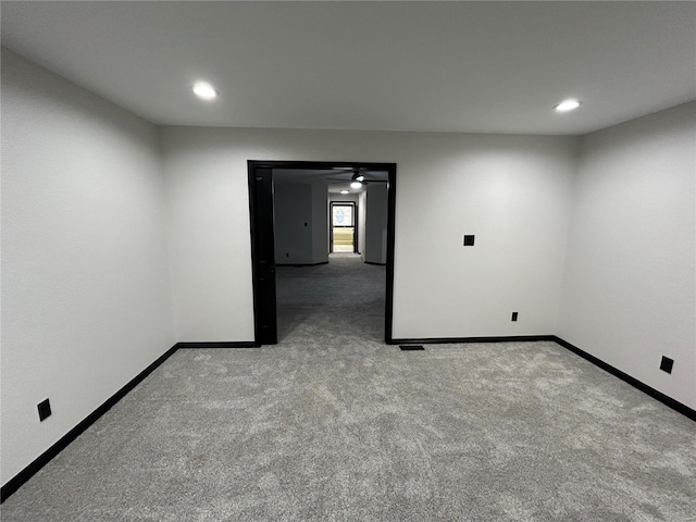 empty room with baseboards, carpet flooring, and recessed lighting