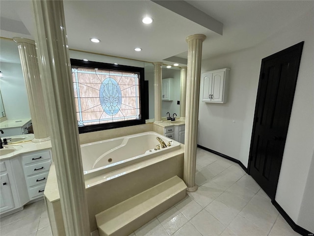 full bath featuring decorative columns, recessed lighting, vanity, baseboards, and a tub with jets