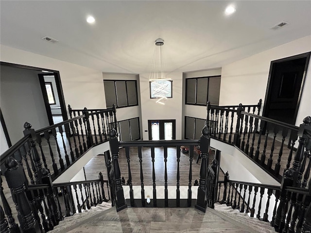 staircase with visible vents and recessed lighting