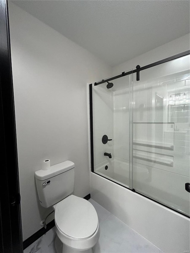 bathroom with shower / bath combination with glass door and toilet