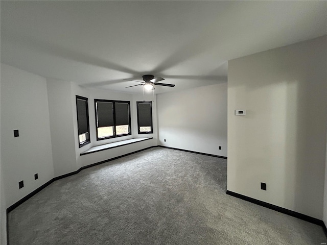 unfurnished room featuring carpet, ceiling fan, and baseboards