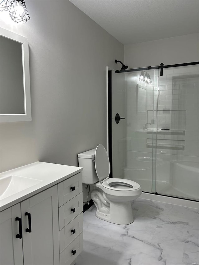 full bath featuring marble finish floor, toilet, vanity, and a shower stall