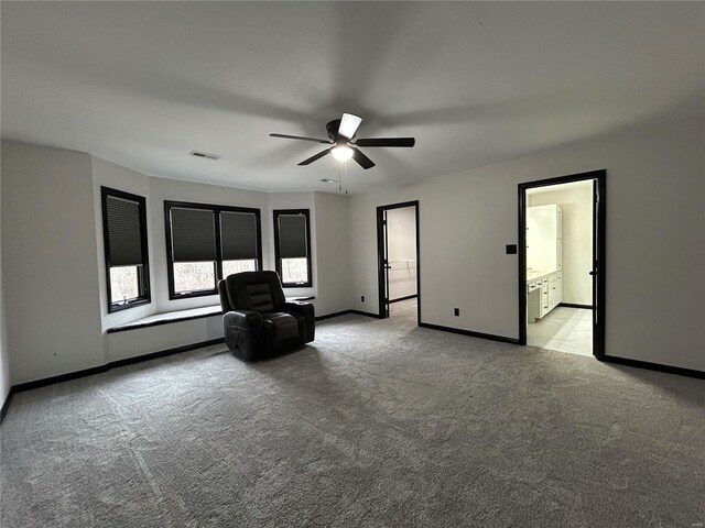 unfurnished room with baseboards, ceiling fan, visible vents, and light colored carpet