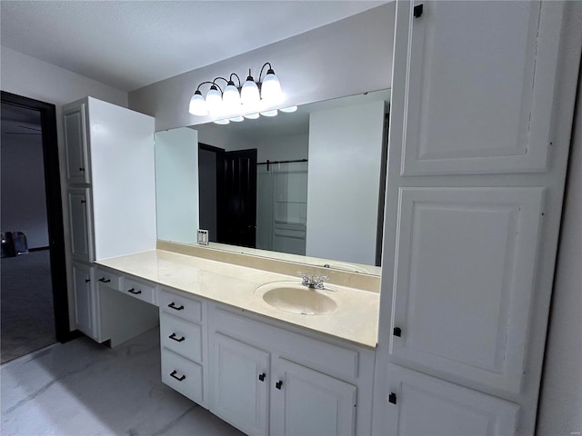 bathroom with marble finish floor and vanity