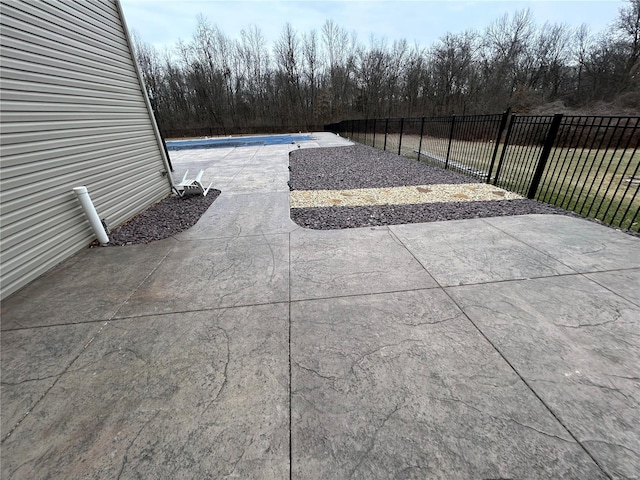 view of patio / terrace featuring a fenced in pool and fence