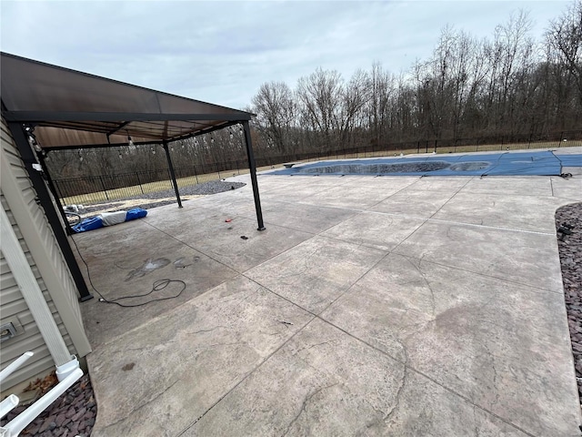 pool with a fenced backyard and a patio