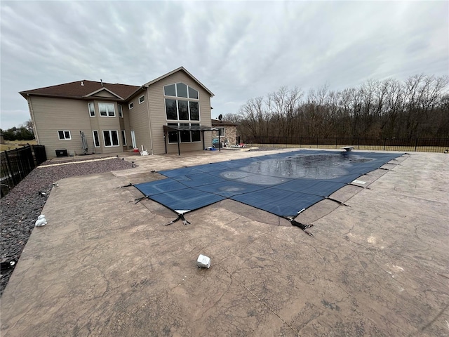 view of swimming pool with a fenced backyard, a fenced in pool, and a patio