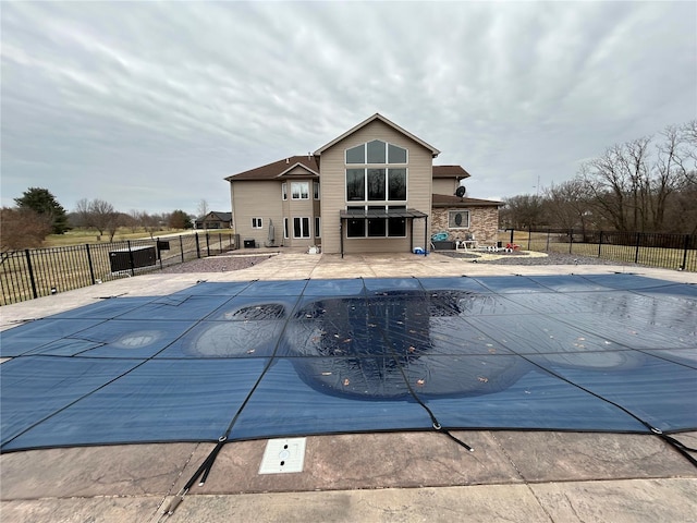 view of pool with a fenced in pool, fence, and a patio