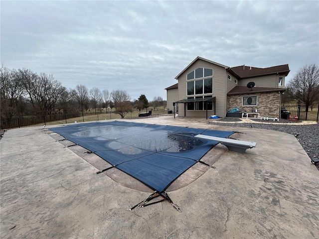 view of swimming pool featuring a patio area, fence, and a fenced in pool