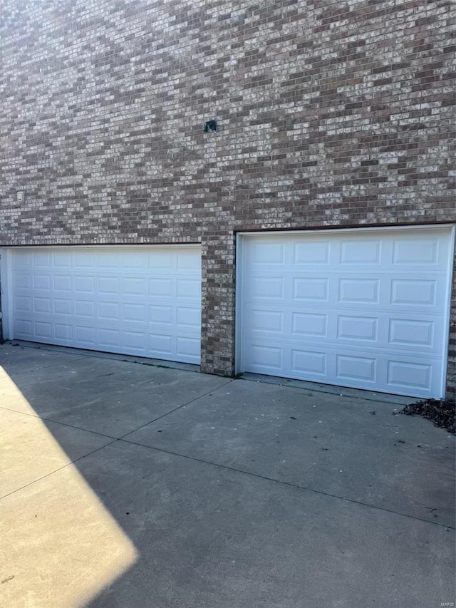 garage featuring concrete driveway