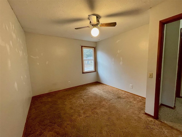 unfurnished room with ceiling fan, carpet floors, and a textured ceiling