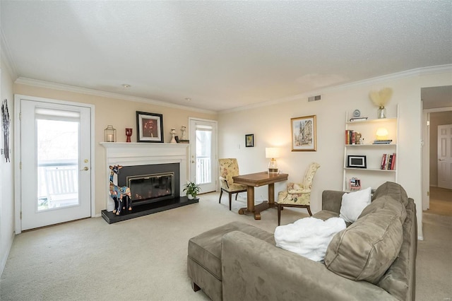 living room with plenty of natural light, a textured ceiling, light carpet, and ornamental molding