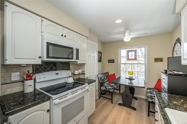 kitchen featuring white cabinets, white range with electric cooktop, light hardwood / wood-style floors, backsplash, and ceiling fan