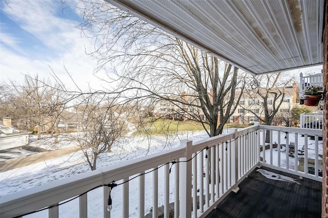 view of snow covered back of property