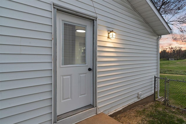 view of exterior entry at dusk