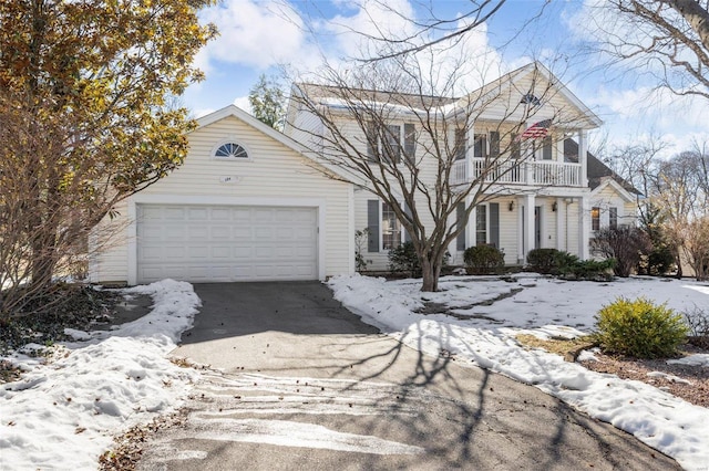 view of front of house featuring a garage and a balcony