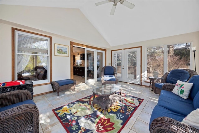 living room with light tile patterned floors, high vaulted ceiling, french doors, and ceiling fan