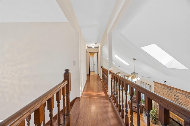 hall featuring dark hardwood / wood-style flooring and a skylight