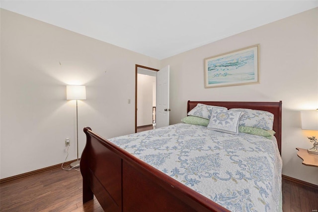 bedroom with dark wood-type flooring