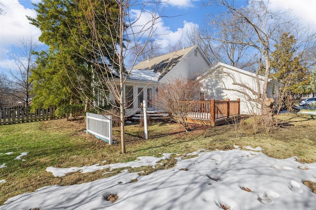 view of side of home featuring a yard and a deck