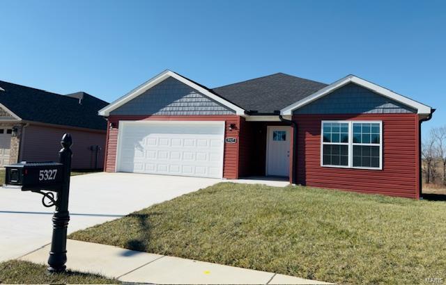 view of front of home with a garage and a front yard