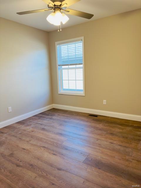 spare room with ceiling fan and hardwood / wood-style floors